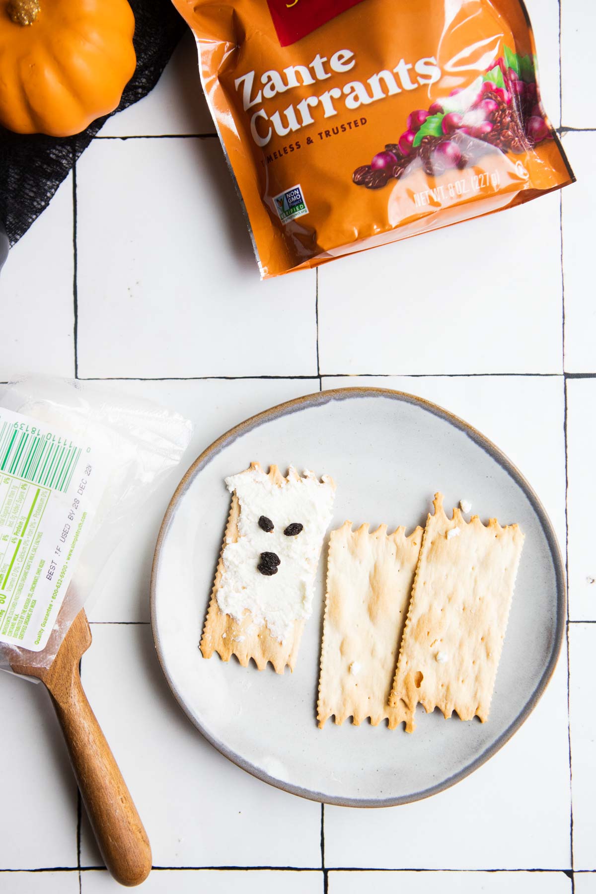 cheese and cracker ghost made with goat cheese crackers and currants