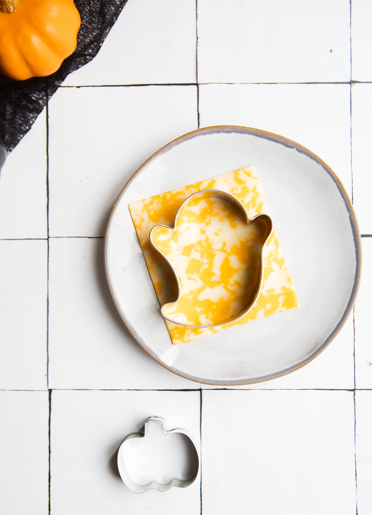 ghost cookie cutter cutting out a piece of cheese