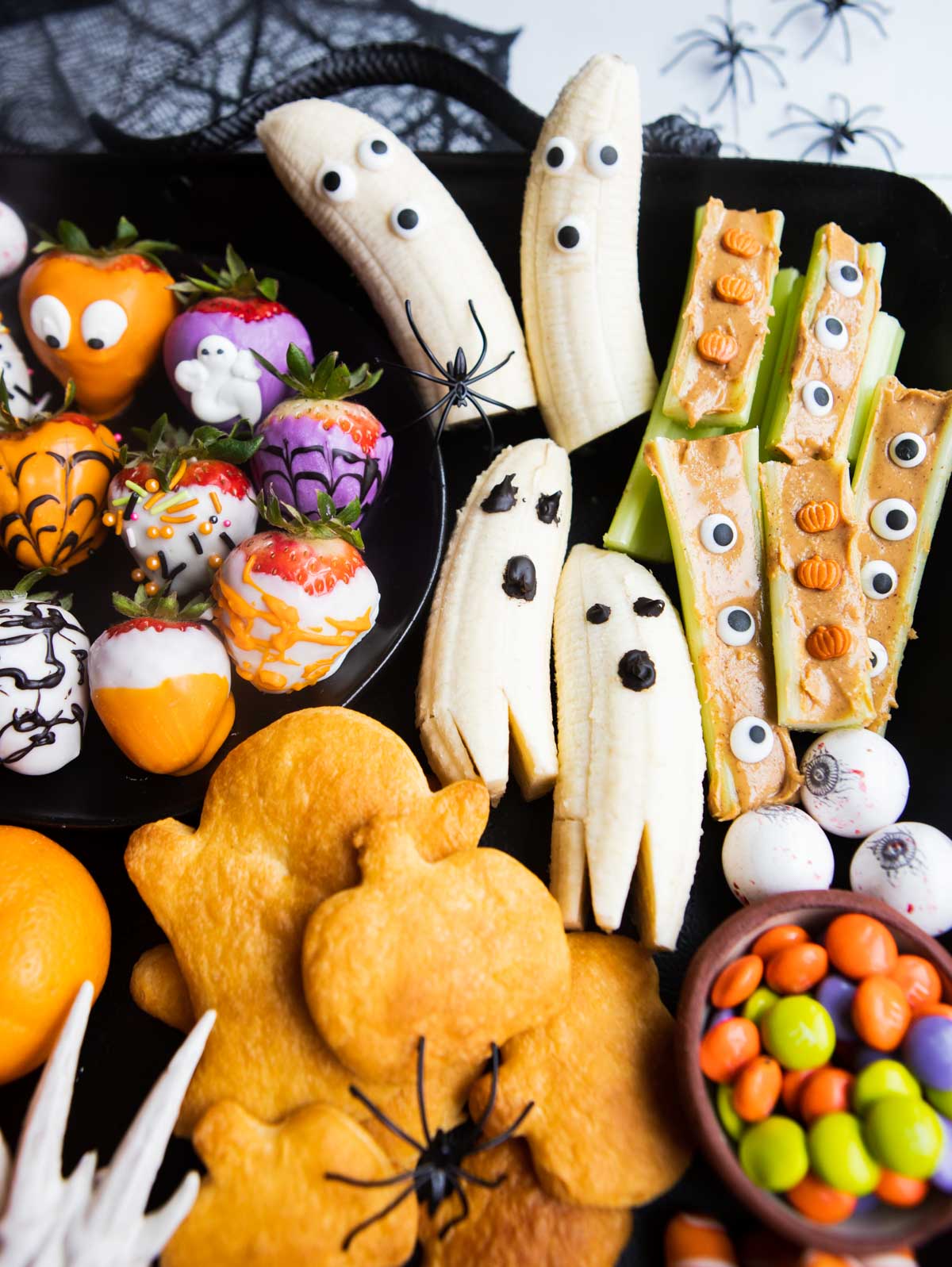 Halloween snack board assembled on a black metal tray