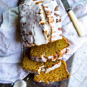 sliced healthy pumpkin banana bread with a glaze on top