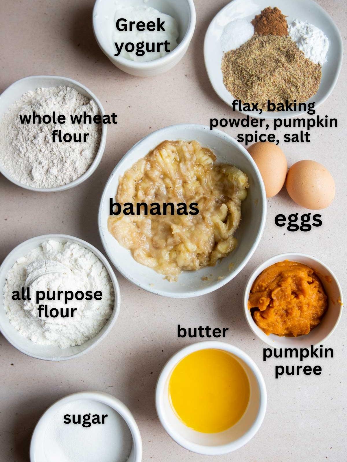 raw ingredients to make pumpkin banana bread in white bowls 