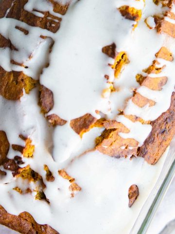 pumpkin pie spice glaze poured all over pumpkin bread