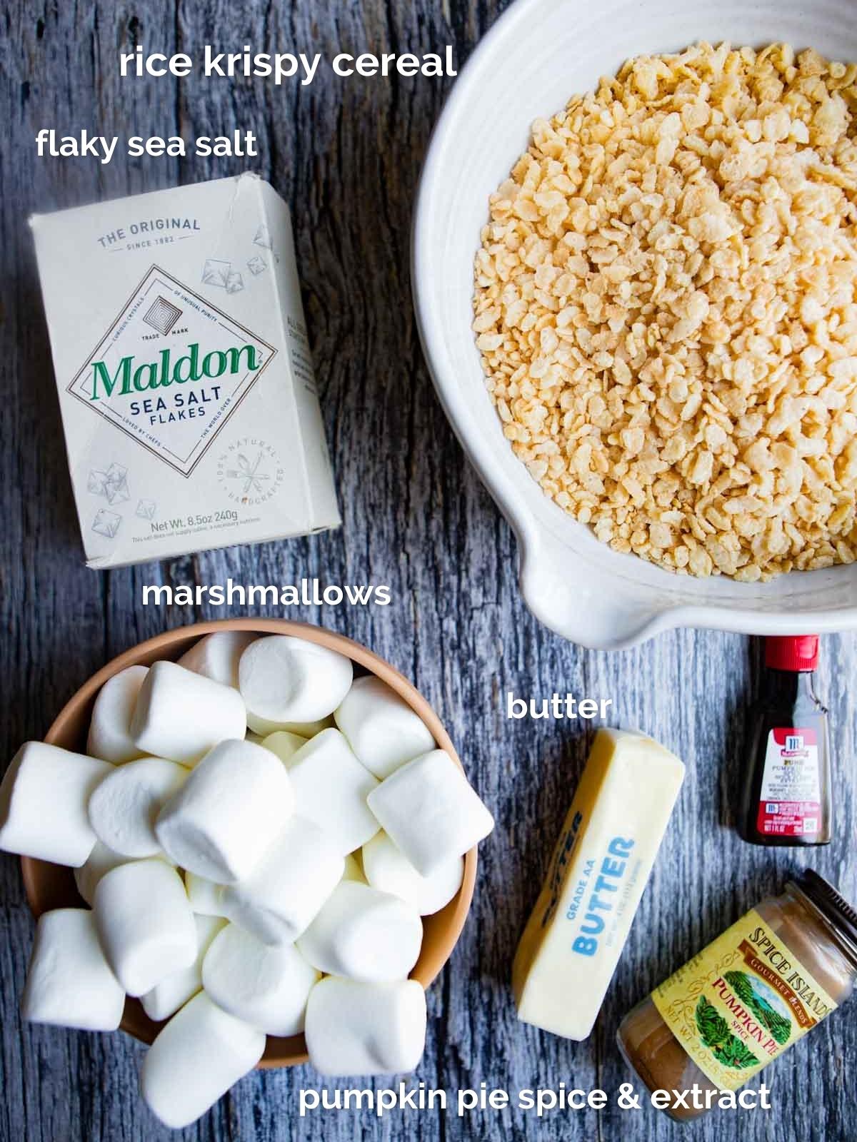 ingredients to make rice krispie treats on a dark gray wooden board