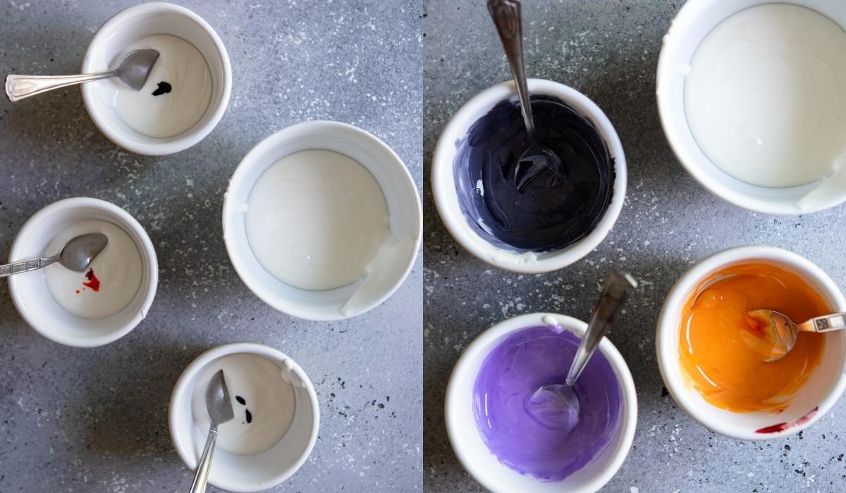 small white bowls filled with royal icing and then colored with food coloring to be orange, purple and black