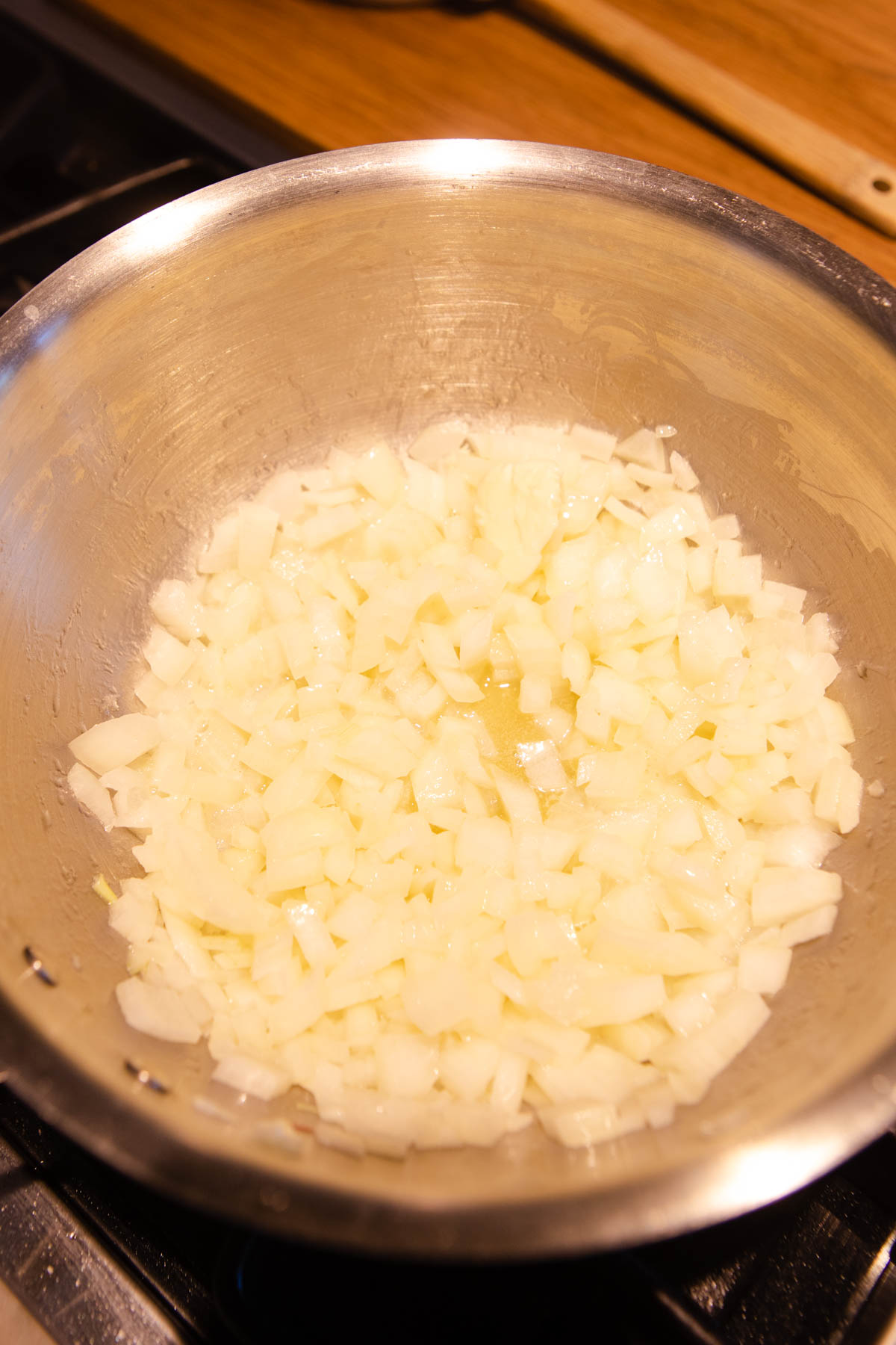 onions sautéing in a large sauce pan