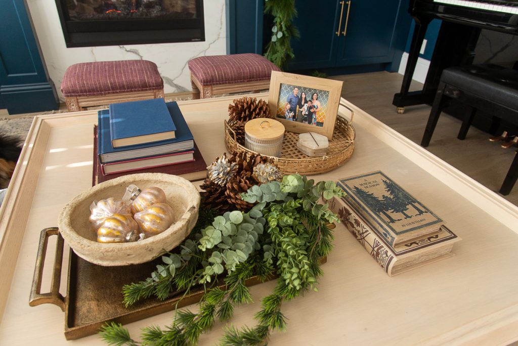 coffee table decorated with books and Christmas garland and ornaments