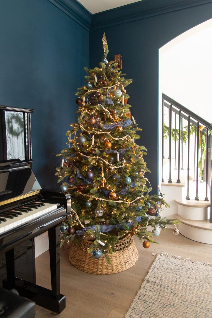 Gentlemen's Gray music room with black piano and Christmas tree