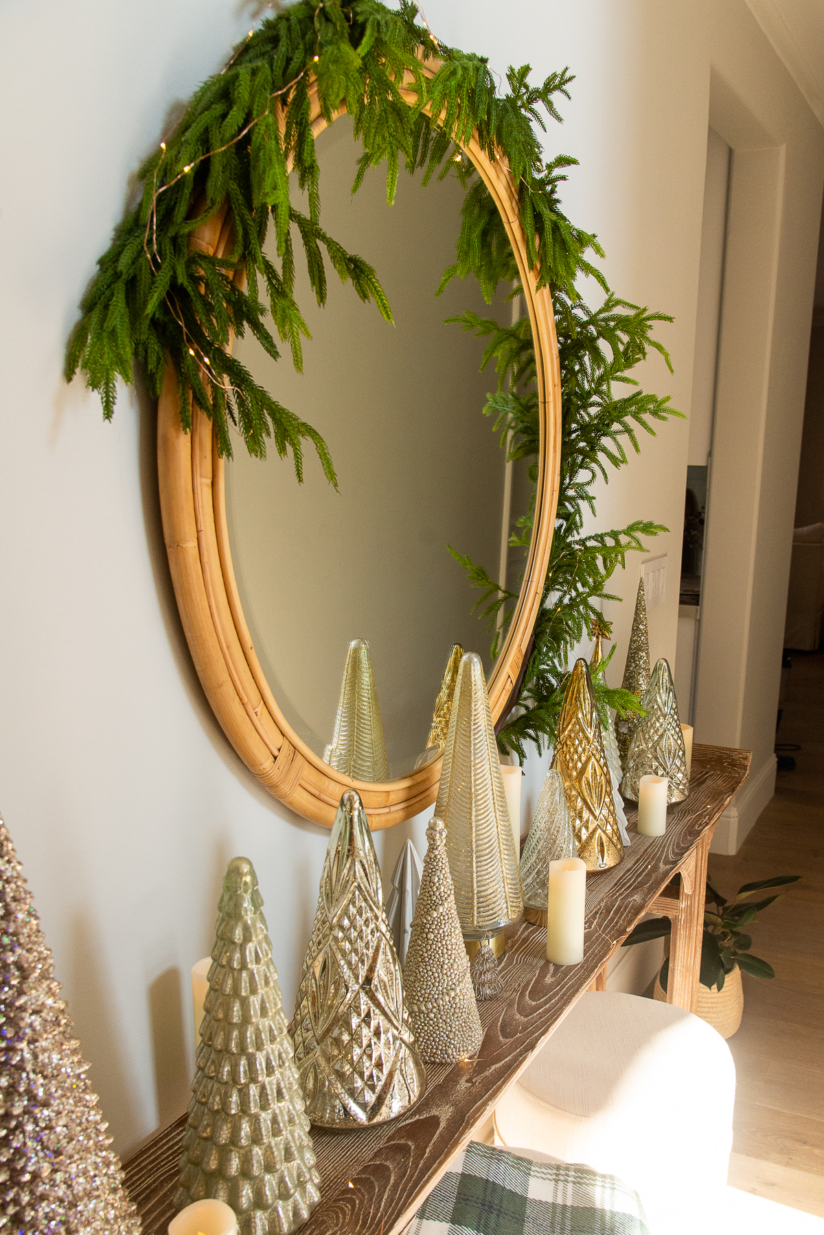 round mirror decorated with Christmas garland