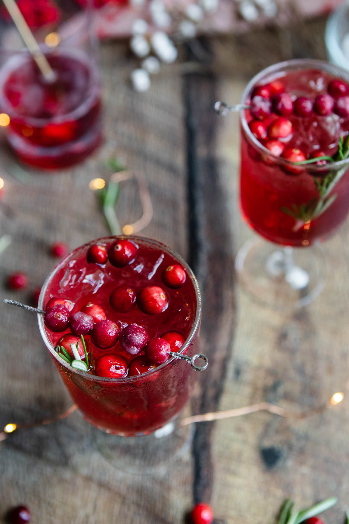 sweet cranberry garnish floating in a cocktail
