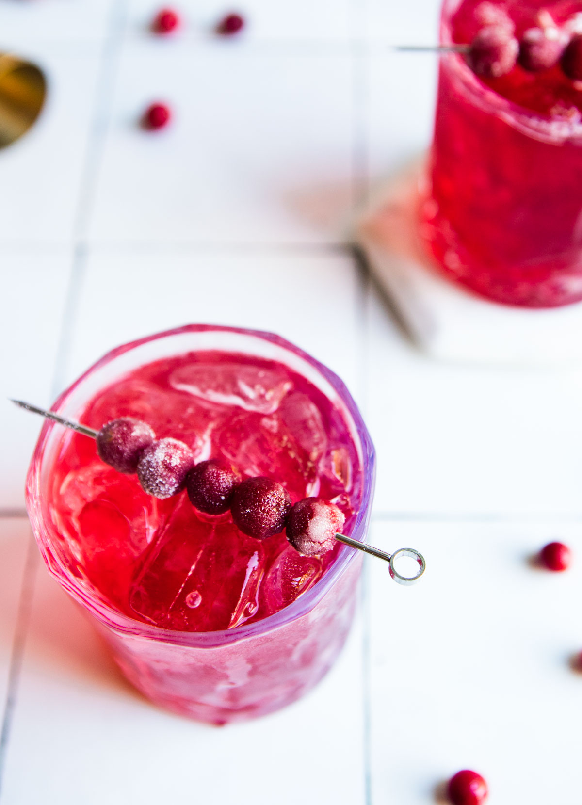 sugared cranberries atop a cranberry cocktail