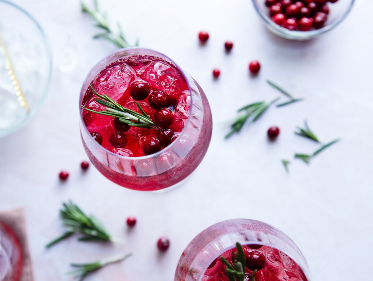 rosemary and sugar cranberries in a Prosecco Christmas cocktail