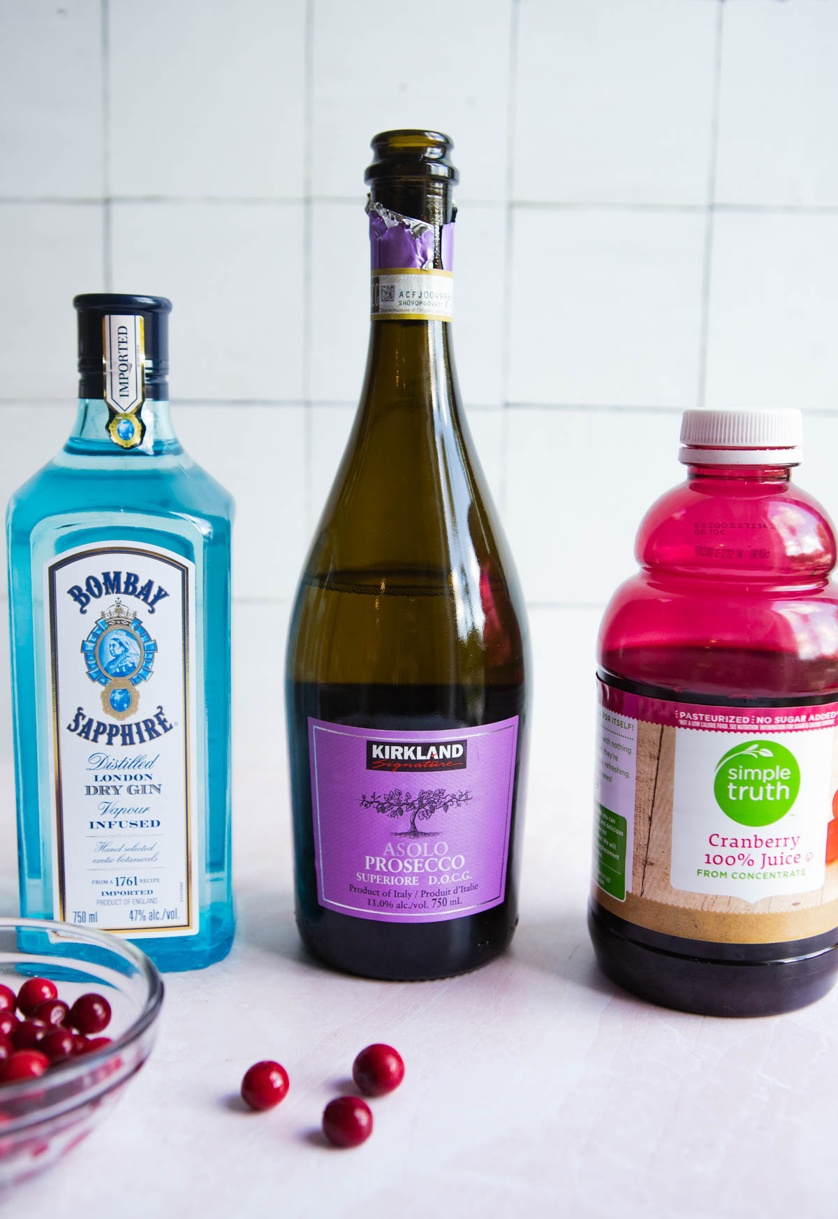 gin, prosecco and cranberry juice bottles