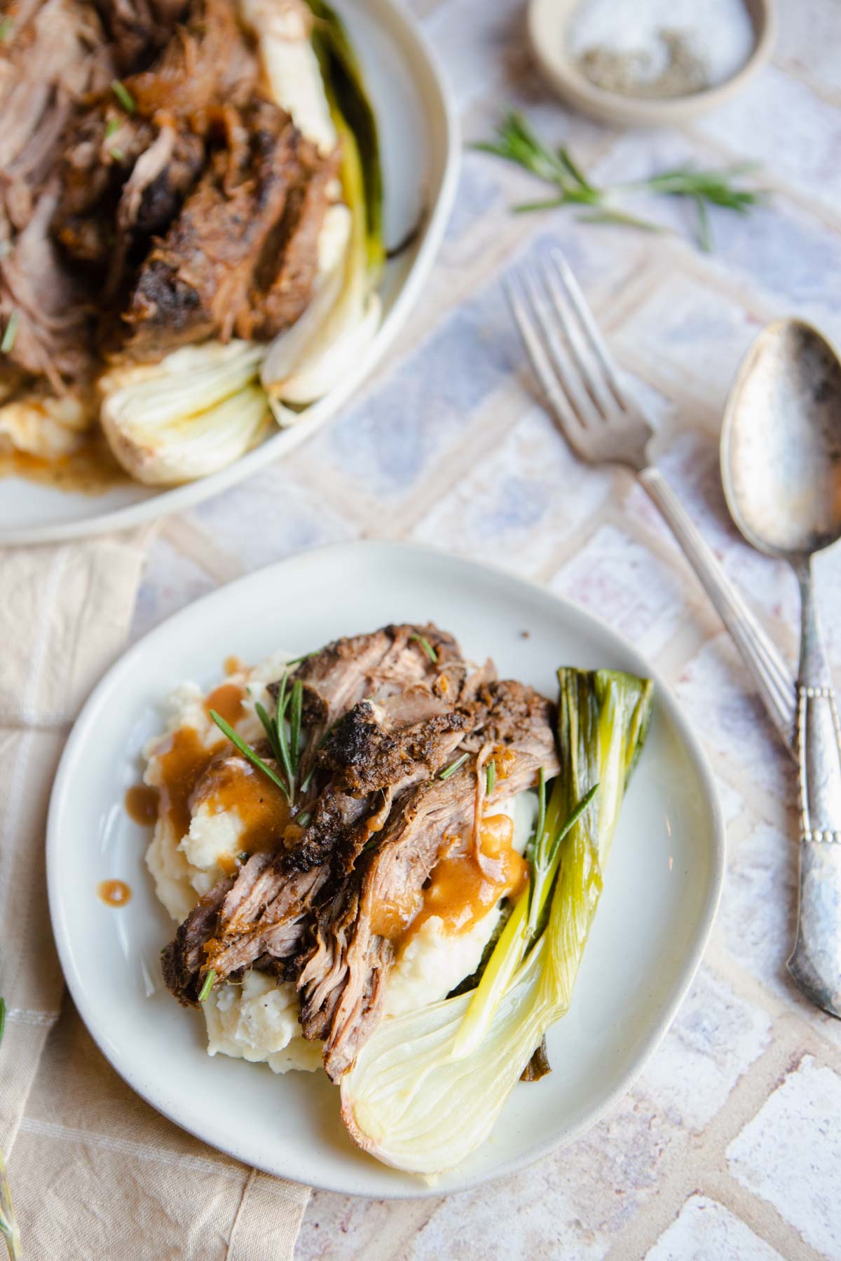 shredded tri tip crock pot recipe set on top of mashed potatoes 