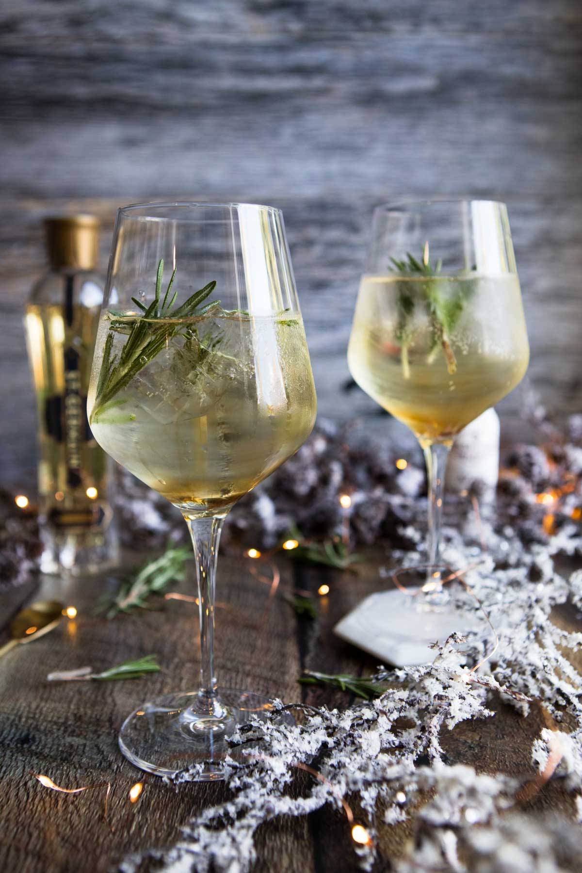winter spritz cocktail in 2 tall wine glasses 