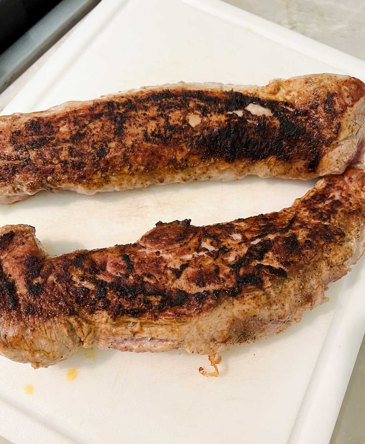 seared pork tenderloin on a cutting board