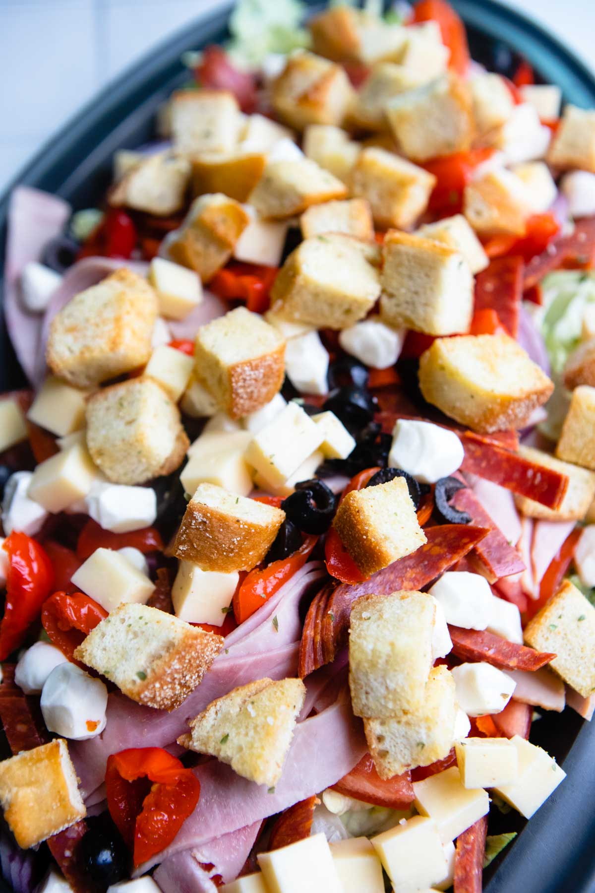 Italian sub salad topped with homemade croutons