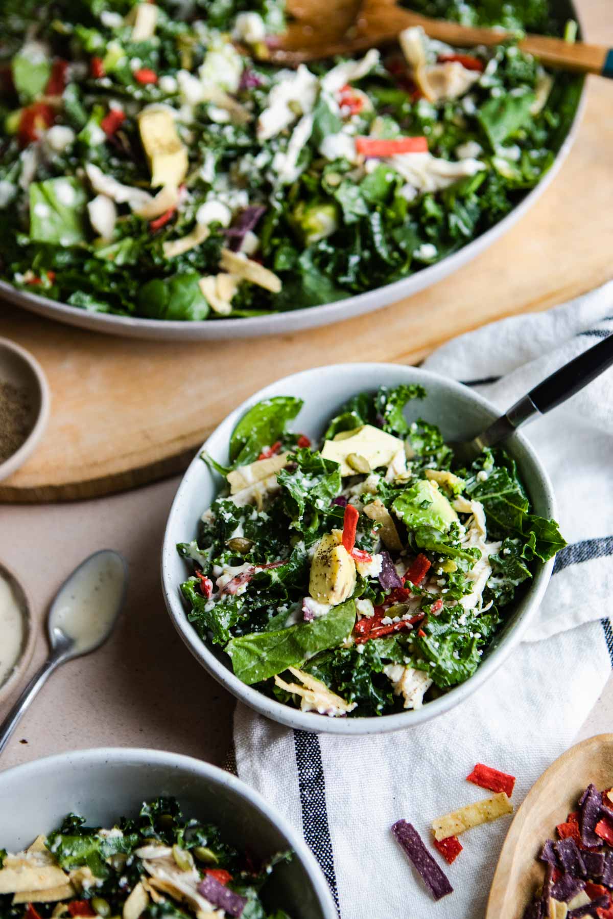 3 bowls filled with Mexican style salad made with kale