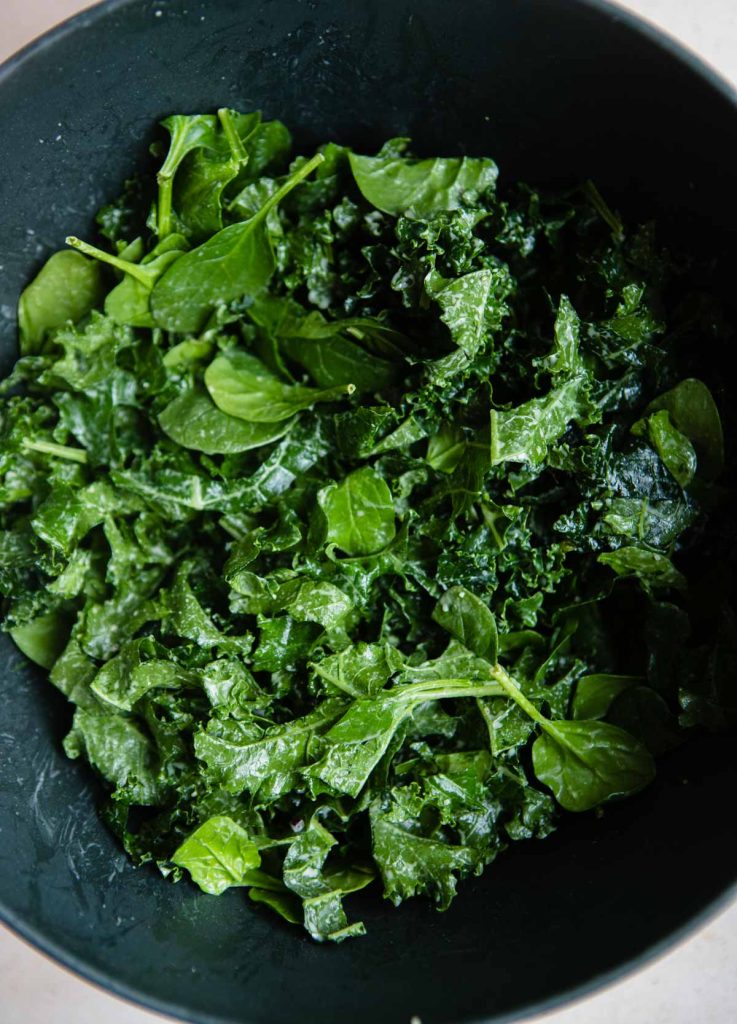 kale and spinach leaves with dressing 