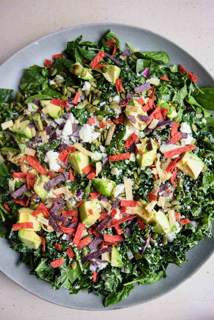 avocados and tortilla strips tossed into a kale salad