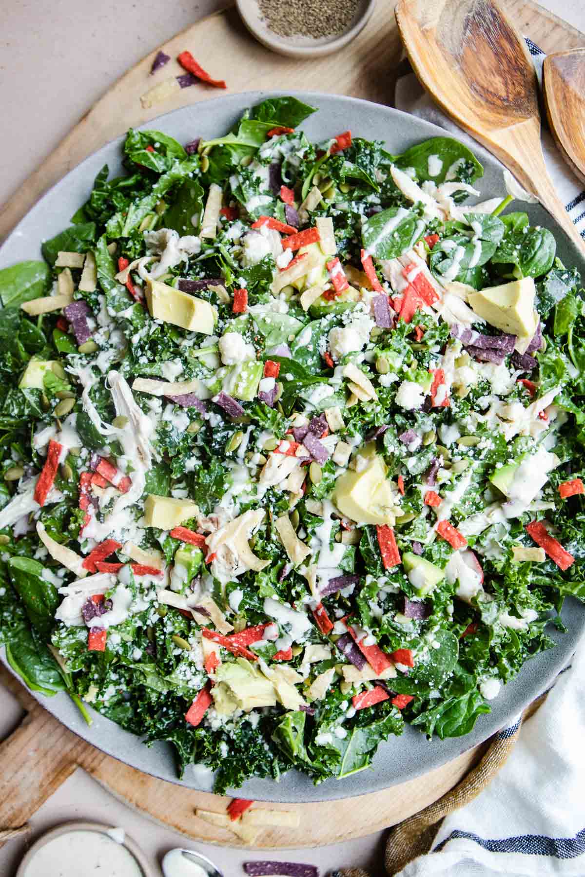 large round tray filled with kale fiesta salad and chicken