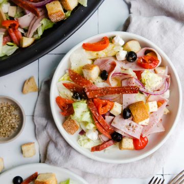 italian cold cut salad on round white plates
