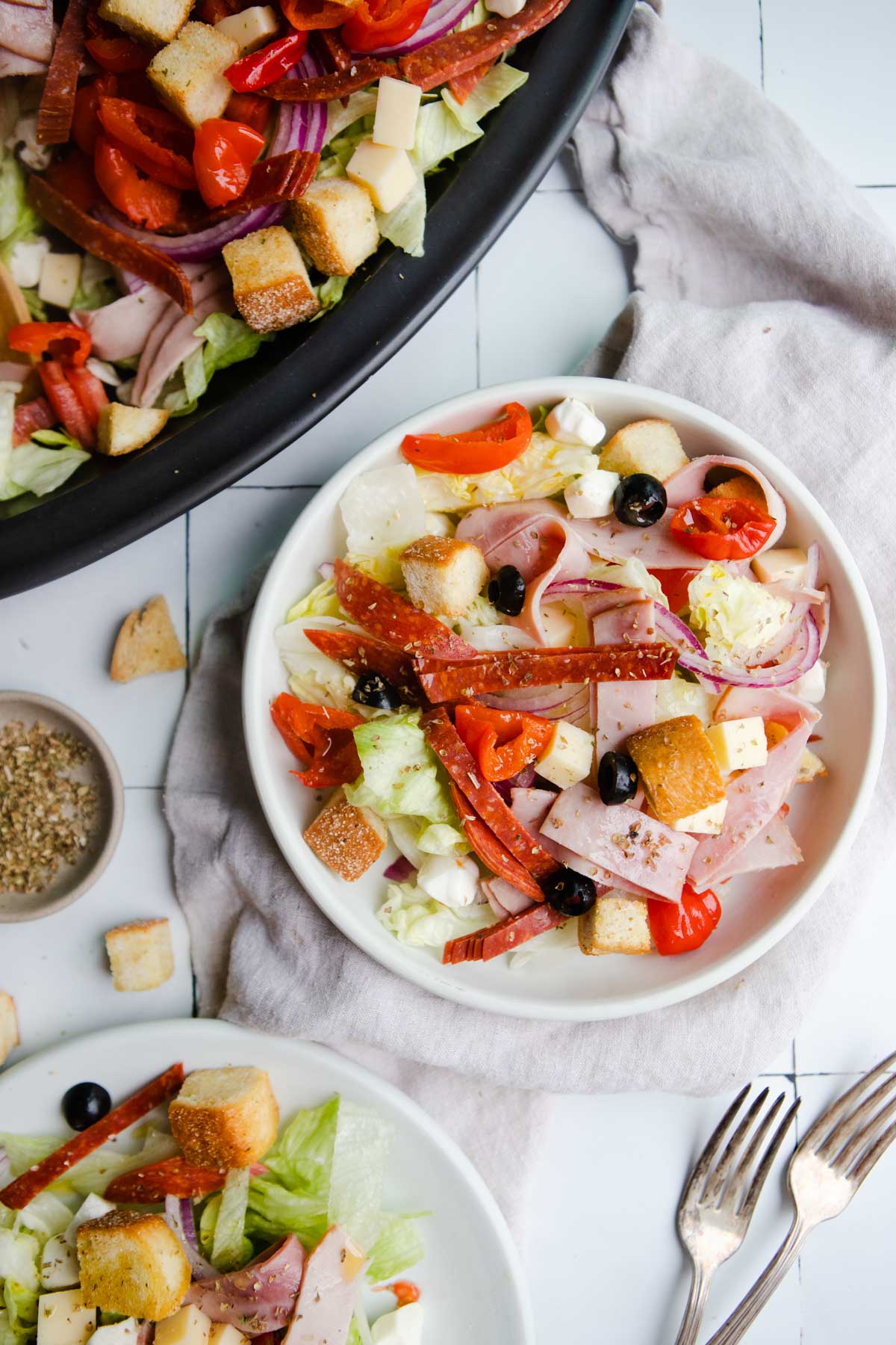 italian cold cut salad on round white plates