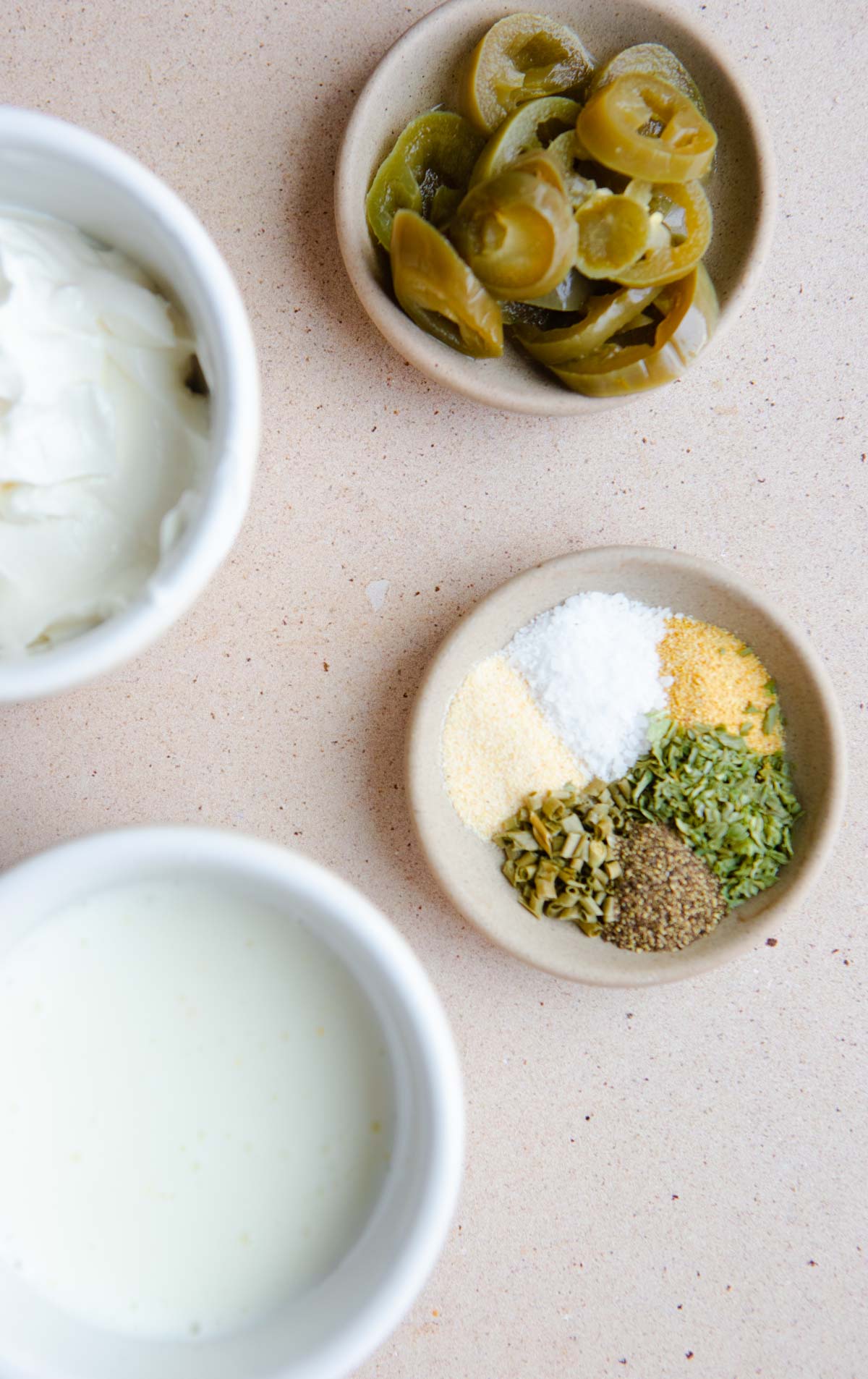 buttermilk, sour cream, jarred jalapenos, garlic powder, salt, parsley and chives in small dishes 