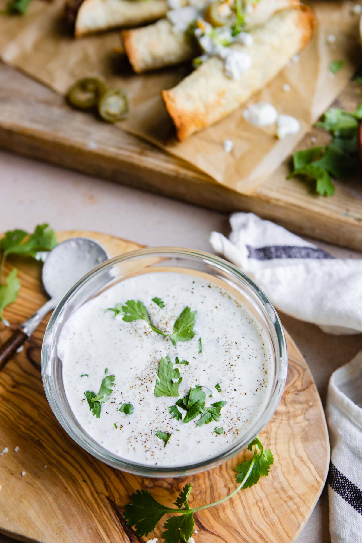 spicy ranch dressing mix in a glass bowl next to air fryer taquitos