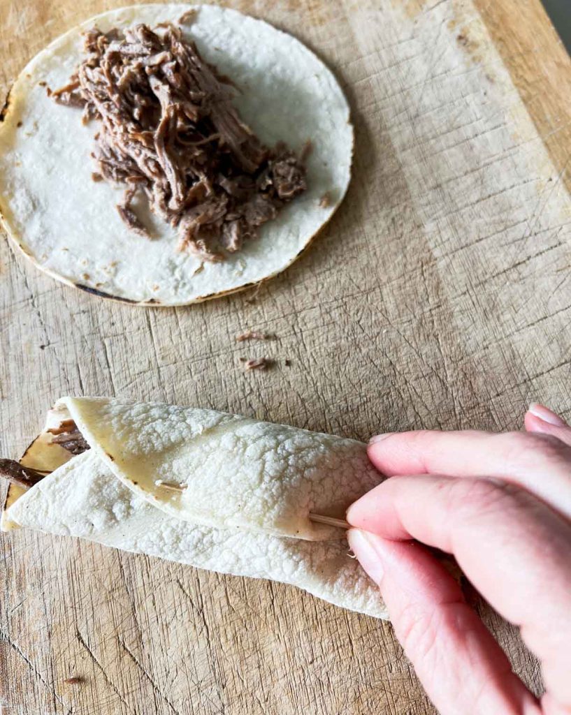 corn tortillas filled with shredded beef and rolled into taquitos