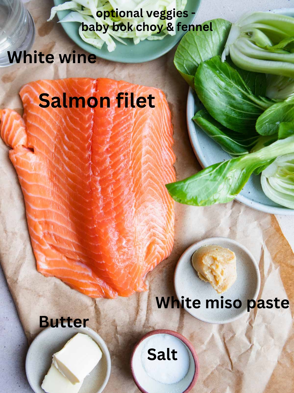 raw salmon, white miso paste, butter, white wine and baby bok choy on a cutting board