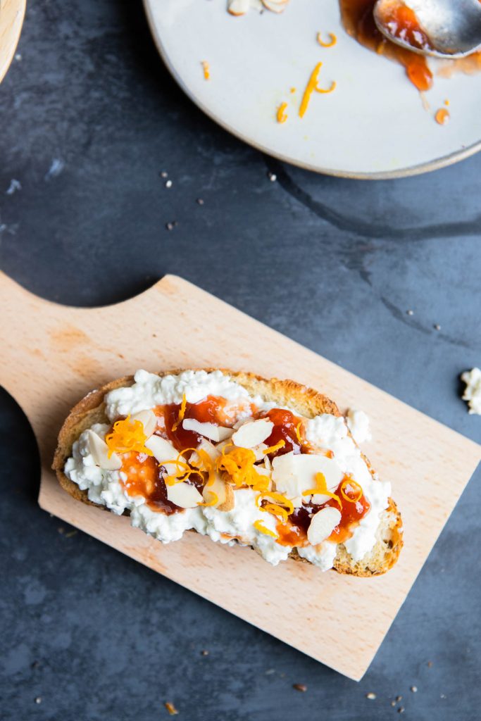 raspberry preserves and orange zest and slivered almonds on cottage cheese and bread