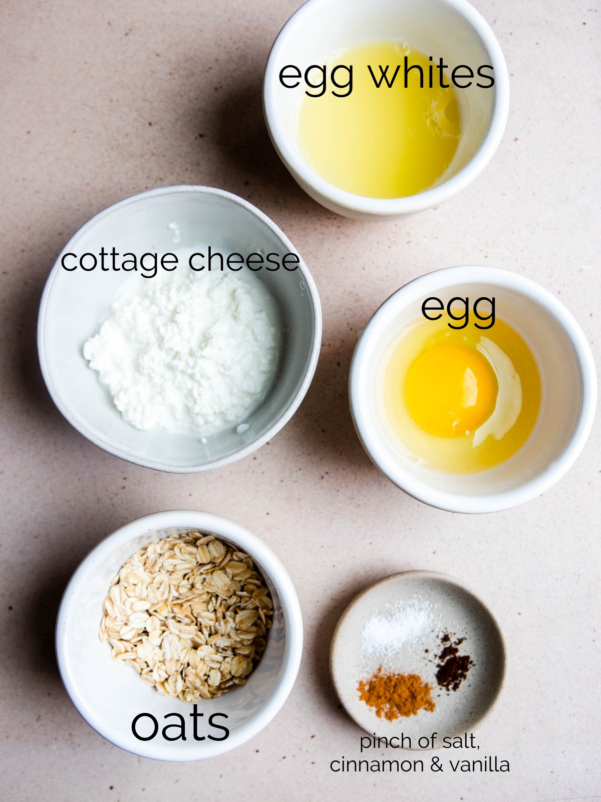 eggs, cottage cheese, egg whites and oats in small white bowls