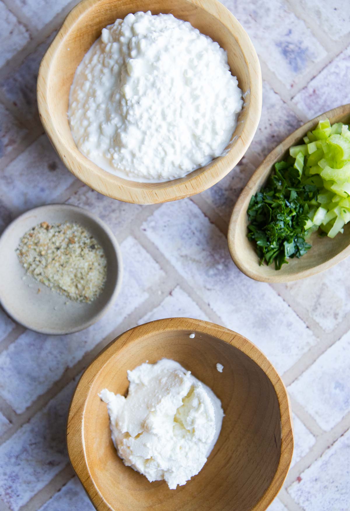 cottage cheese, ricotta, lemon pepper and diced celery in small bowls