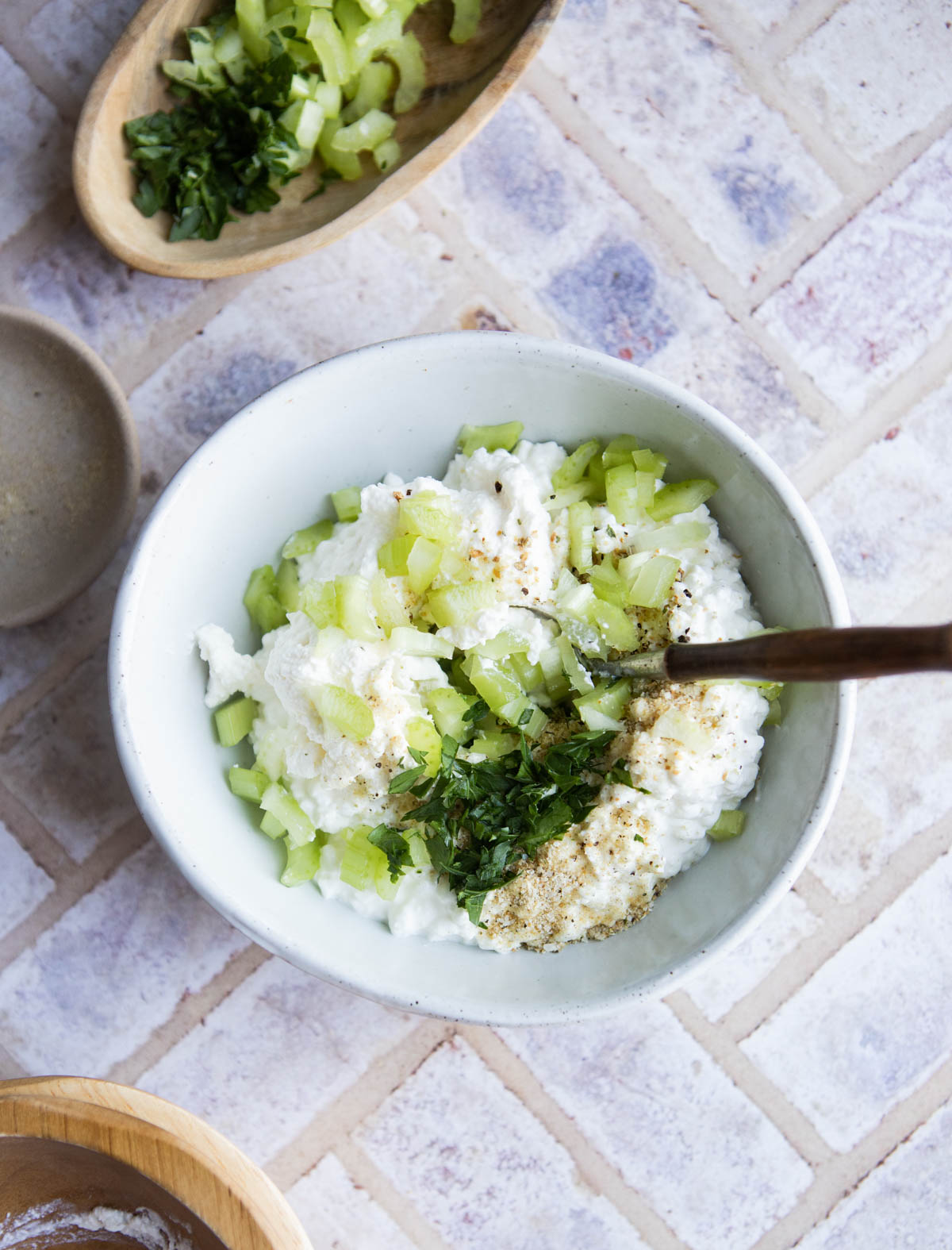 ingredients to make lemon pepper cottage cheese dip in a white bowl