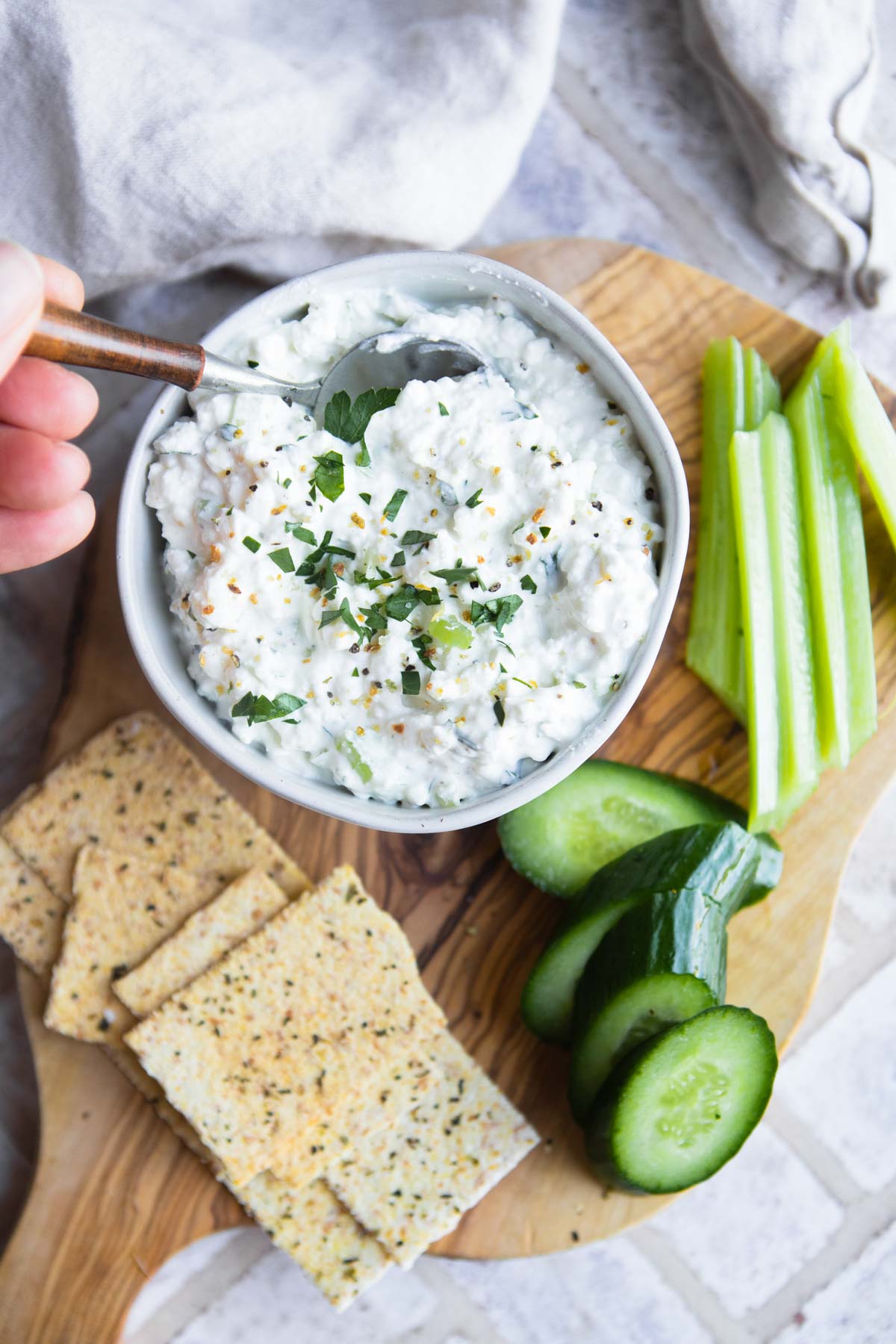 spooning out cottage cheese dip for crackers 