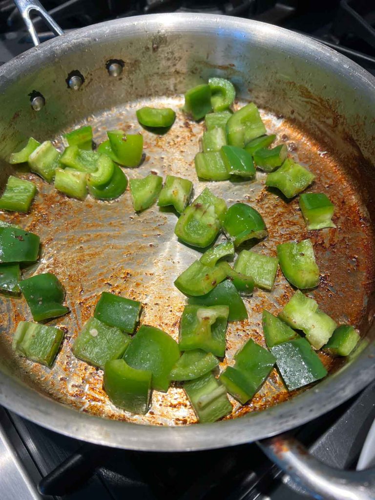 green peppers cooking in a frying pan
