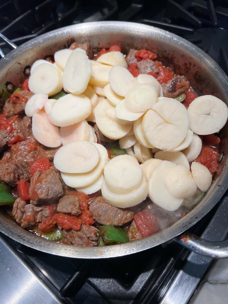 canned potatoes added back into frying pan with steak and peppers
