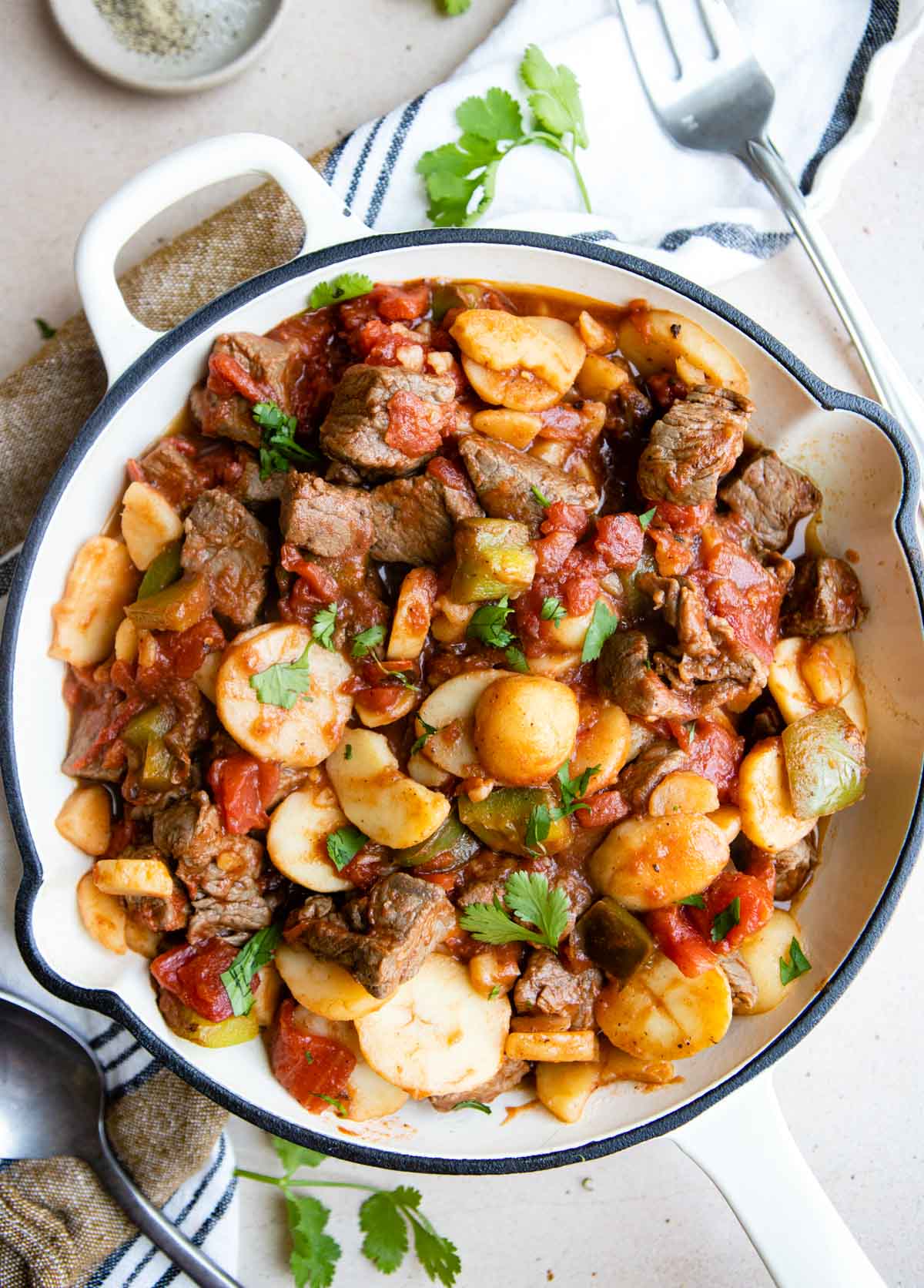 white enameled cast iron skillet filled with steak picado 