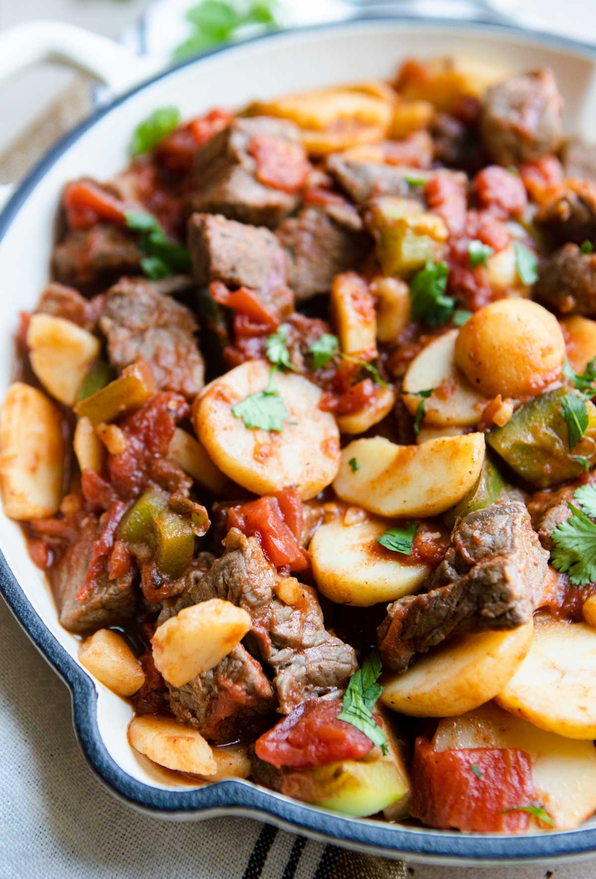 warm steak picado in a white enamel cast iron skillet