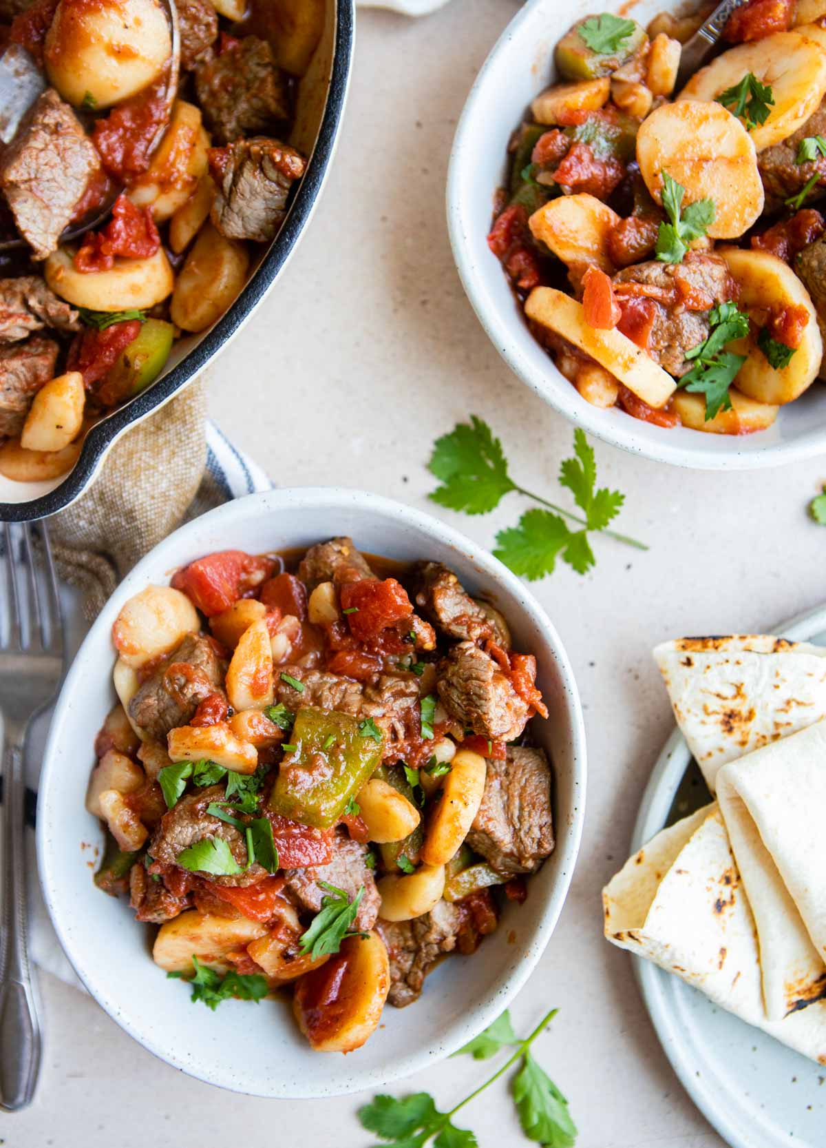 steak picado and potatoes dished up in a bowel and served with warm tortillas