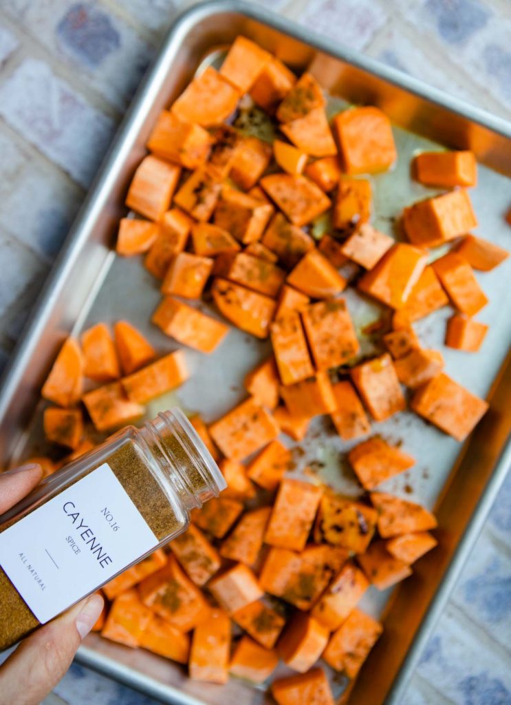 cubed and peeled sweet potatoes with cayenne sprinkled on them