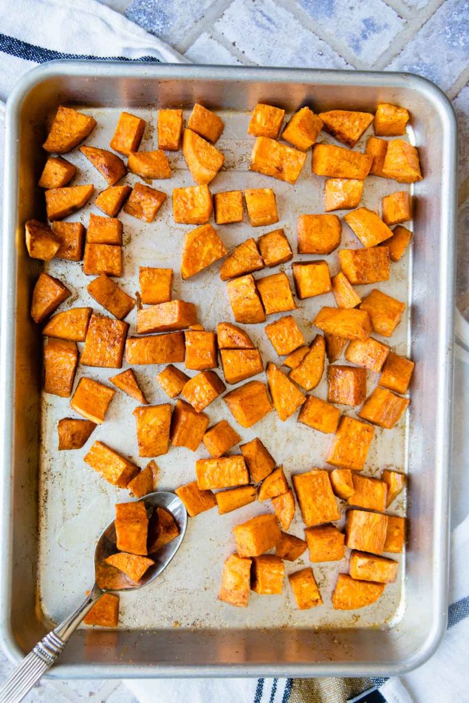 roasted sweet potatoes on a rimmed sheet pan