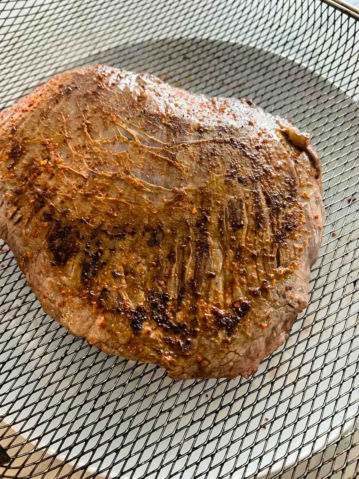 Air fryer flank steak seasoned and cooked.