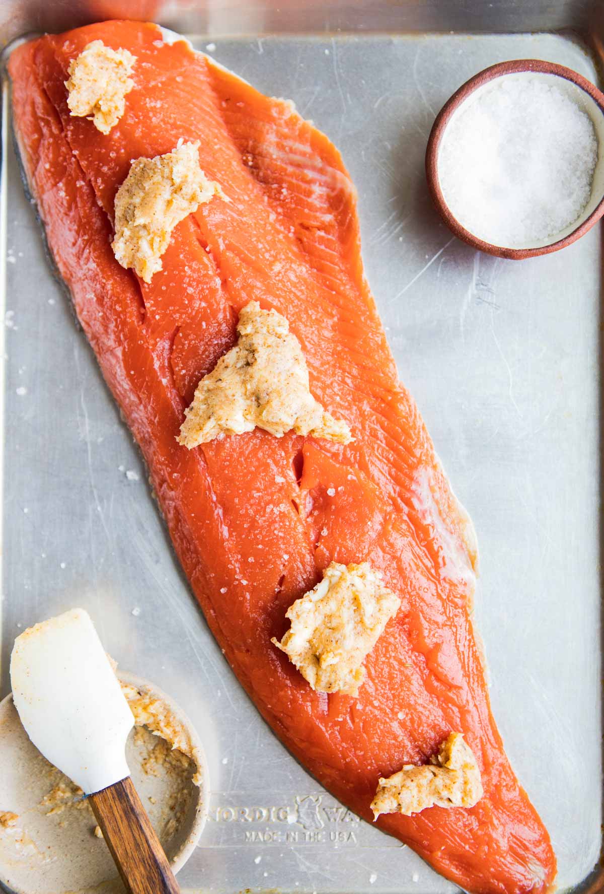 compound butter pads on top of a salmon filet