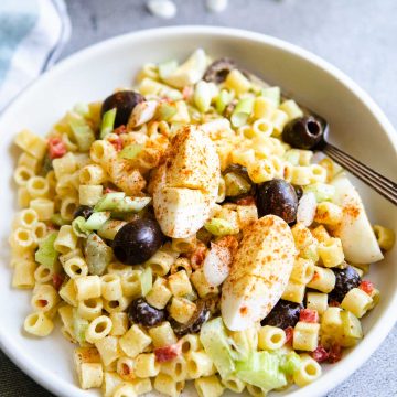 Souther macaroni salad with paprika garnished over the top of the veggies and ditalini pasta.