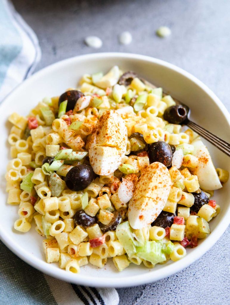 Souther macaroni salad with paprika garnished over the top of the veggies and ditalini pasta.