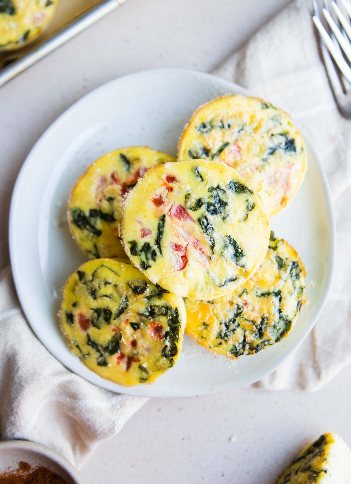 Top view of a plate stacked with soft egg bites.