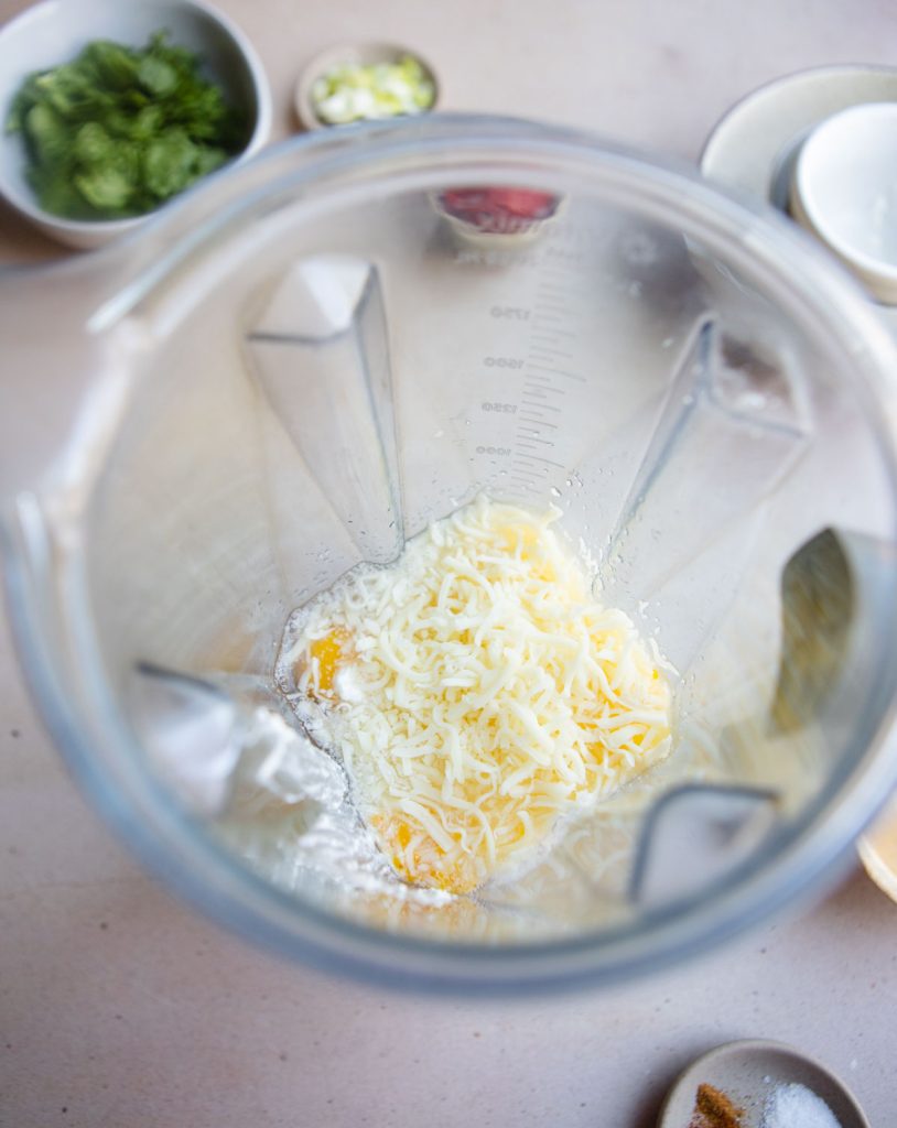 Cheese added to the eggs in a blender.