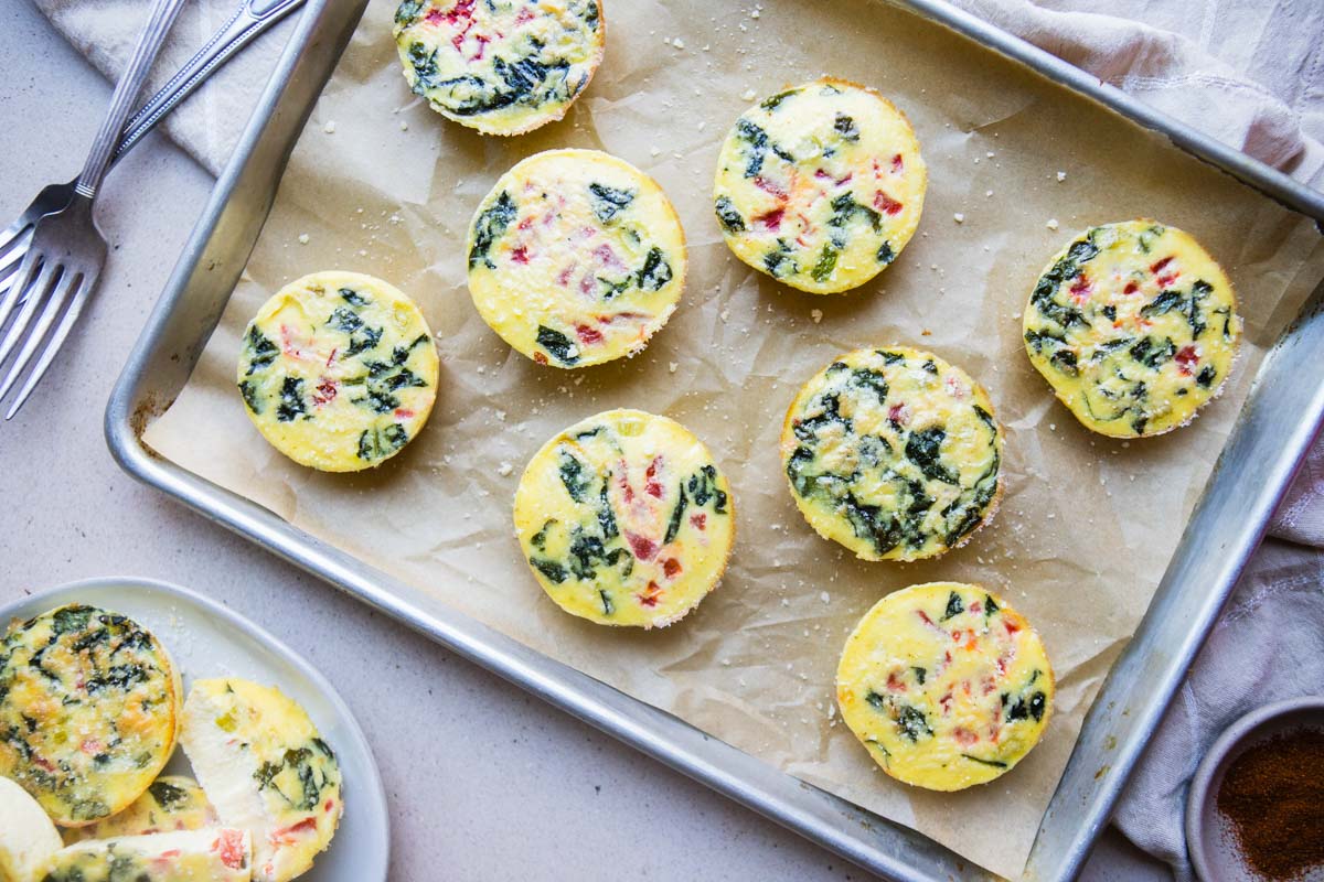 Parchment paper covered baking sheet with Starbucks egg white bites laid out over the pan.