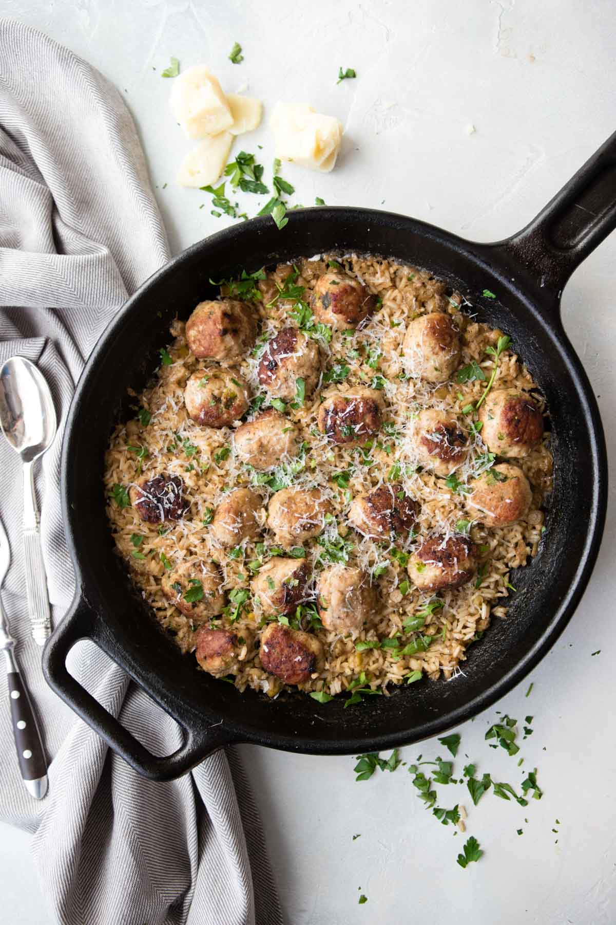 turkey meatballs and brown rice in a black cast iron skillet